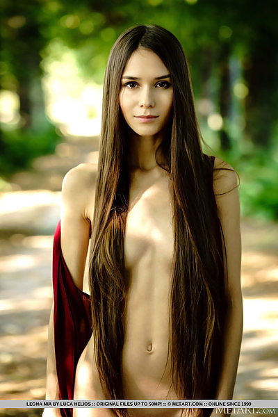Long-haired brunette teen nude on a bench