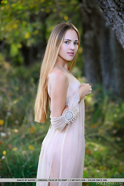 Pale blonde nude by a forest