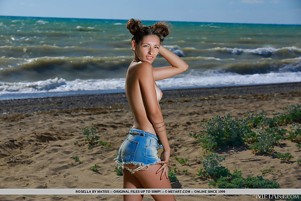 Flat-chested brunette takes off her jean shorts at the beach