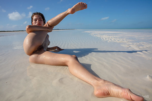 Flexible Latina spreading at the beach