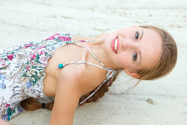 Cute blonde teen nude in the sand