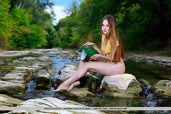 Sexy blue-eyed girl spreads her ass by a creek