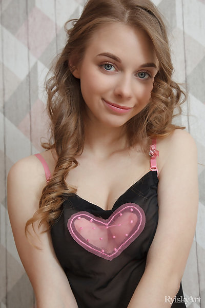 Cute teen with blue eyes takes off her see-through tank top
