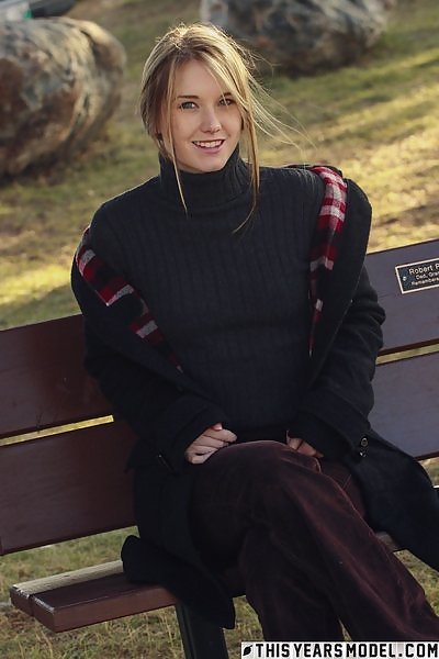 Freckled blonde stripping on a bench