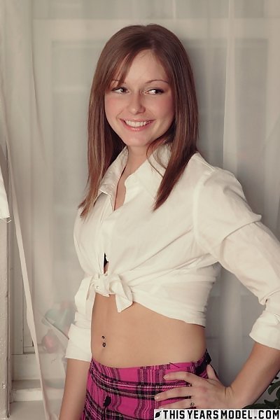 Cute freckled girl lifts up her skirt