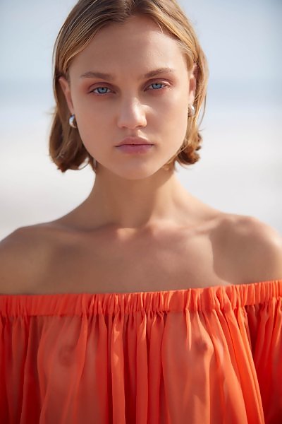 Skinny girl with amazing blue eyes at the beach