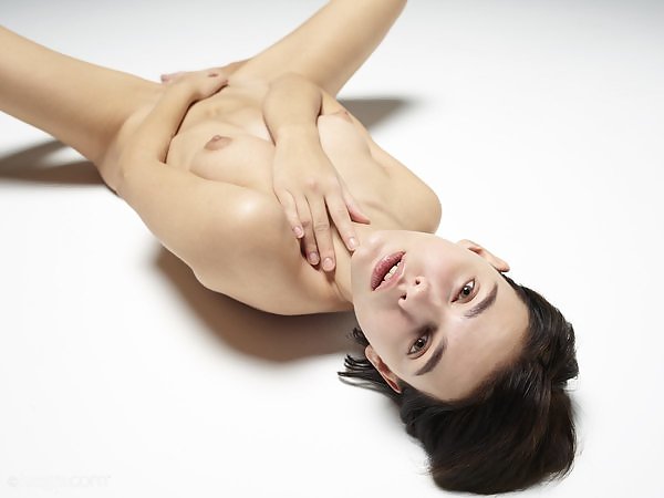 Short-haired brunette posing nude in studio