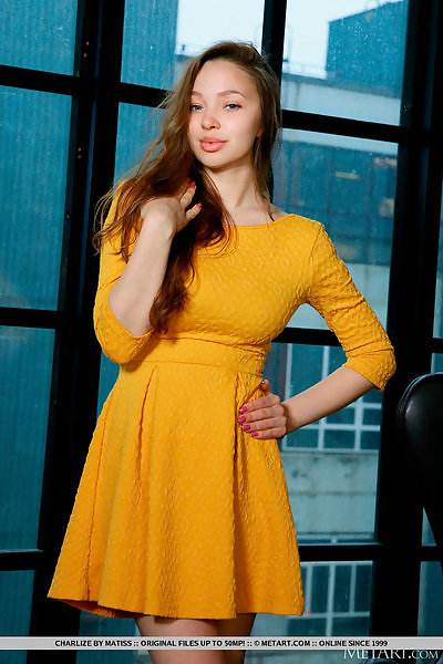 Busty brunette takes off her yellow dress
