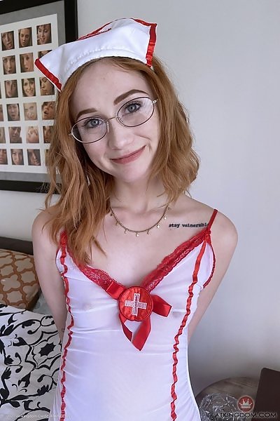 Naughty redhead nurse shows off her asshole