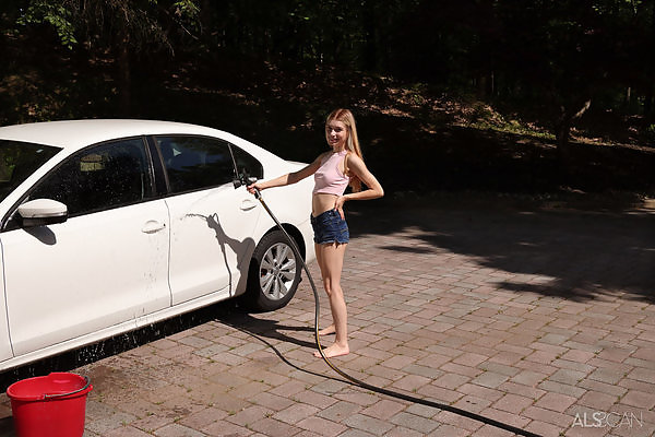 Pale blonde cutie toying her shaved pussy by her car