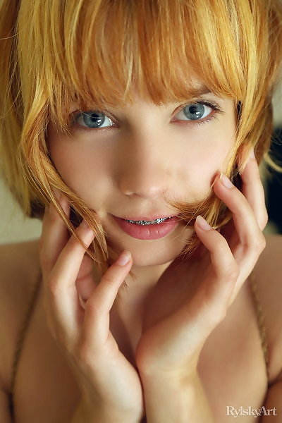 Cute redhead with blue eyes posing nude