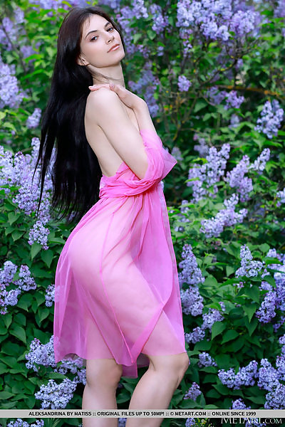 Shaved girl with black hair takes off her see-through dress outdoors