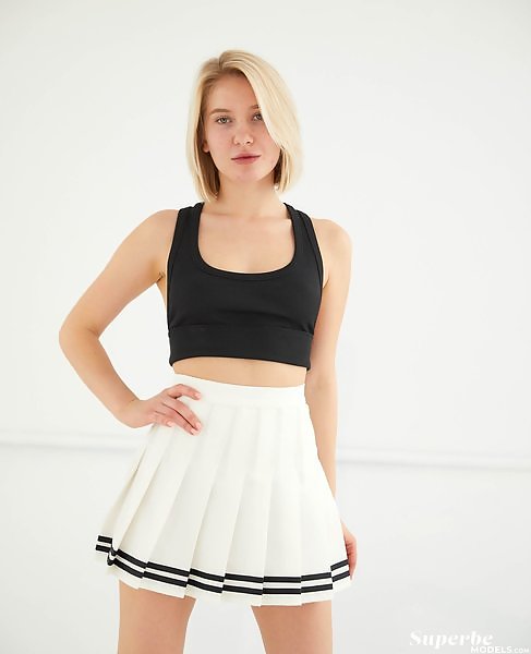 Natural blonde with green eyes lifts up her skirt