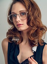 Flat-chested redhead with glasses stripping
