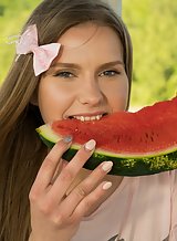 Shaved teen with long socks eating watermelon