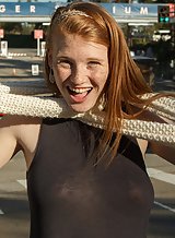 Freckled redhead teen flashes her tits