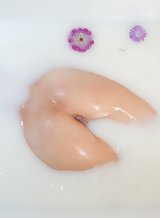 Shaved teen bathing in milk