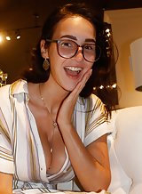 Nerdy brunette with big tits flashing in a store