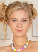 Blonde teen with blue eyes spreading on a chair