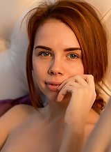 Cute redhead teen nude in bed