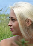 Blonde teen naked in a field