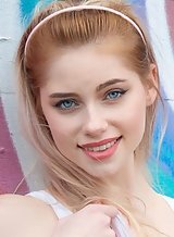 Blue-eyed blonde with pale skin lifts up her skirt