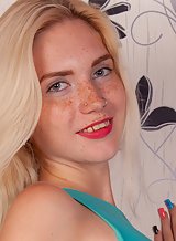 Freckled blonde girl spreads her holes