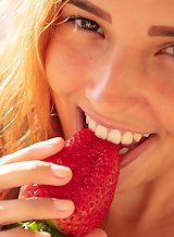 Freckled redhead Latina plays with fruits