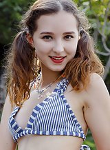Cute teen with pigtails takes off her bikini outdoors