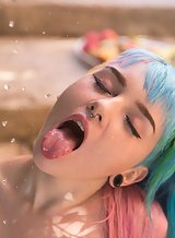 Suicide girl with rainbow hair showing bubble butt in sexy bikini pics