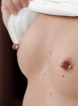 Short-haired blonde with pierced nipples masturbating