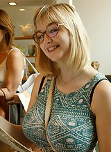 Nerdy blonde flashes her big tits in a store