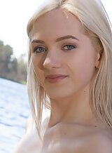 Sexy blonde with pale skin nude by a lake