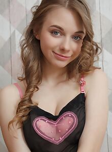 Cute teen with blue eyes takes off her see-through tank top
