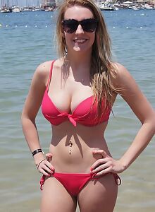 Busty blonde takes off her bikini top at the beach