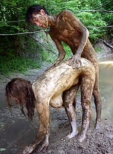 Crazy couple having fun in the mud