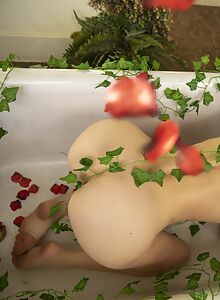 Redhead with short hair nude in the bathtub