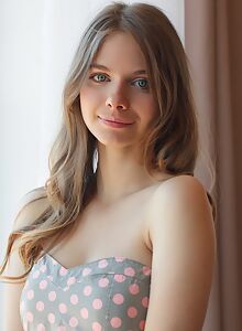 Cute girl with amazing blue eyes lifts up her dress