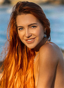 Redhead beauty exposes her sexy curves on a tropical island