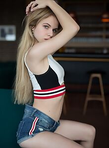 Sexy blonde takes off her jean shorts