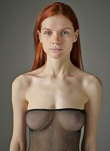 Skinny redhead model with big boobs in a fishnet dress