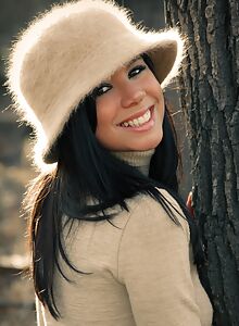 Black-haired cutie stripping in a forest