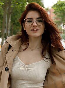 Nerdy redhead goes topless in the city