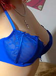 Redhead in blue lingerie flashes her boobs