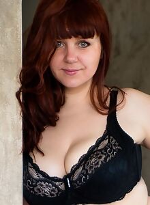 Curvy redhead with big boobs in lingerie