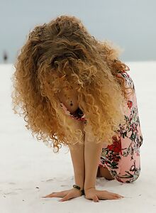 Cute hairy blonde flashes her tits in the sand