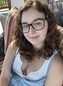 Nerdy brunette spreads her ass and pussy on the balcony