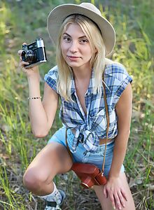 Cute shaved blonde takes off her jean shorts outdoors
