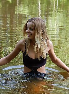 Tanned girl nude in a lake and forest
