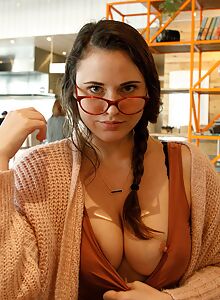 Nerdy brunette flashes her big tits in public